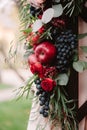 Autumnal wedding composition of roses, apples, grape and pomergranate