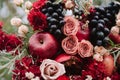 Autumnal wedding composition of roses, apples, grape and pomergranate