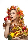 Autumnal woman. Beautiful creative makeup and hair style in fall concept studio shot. Beauty fashion model girl with fall makeup