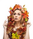 Autumnal woman. Beautiful creative makeup and hair style in fall concept studio shot. Beauty fashion model girl with fall makeup