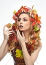 Autumnal woman. Beautiful creative makeup and hair style in fall concept studio shot. Beauty fashion model girl with fall makeup