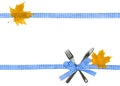 Autumnal yellow maple leaves, fork, knife with square-textured blue and white ribbon on white background with space for text Royalty Free Stock Photo