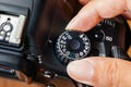 Av dial mode on dslr camera with fingers on the dial Royalty Free Stock Photo