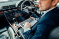 Focusing on work. businessman working on laptop while sitting on back seat car