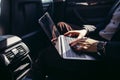 Focusing on work. businessman working on laptop while sitting on back seat car Royalty Free Stock Photo