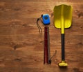 Avalanche rescue kit, lying on wooden floor.