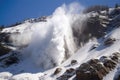 avalanche of snow and ice crashing down mountainside