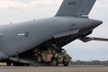 Australian Army Bushmaster armoured Personnel carrier APC unloading from a Royal Australian Air Force Boeing C-17A Globemaster t