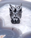 Avalon dragon skull on polished large natural agate slab from Brazil. Healing Crystal. Royalty Free Stock Photo