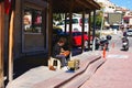 Man is polishing leather shoes, shoeshine on street. Shoe shiner with traditional equipment at work on the sidewalk Royalty Free Stock Photo