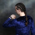 Attractive male model with braids posing in studio. Avantgarde, style, fashion concept.