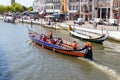 Aveiro, Portugal - July 17, 2019: A group of tourist in Moliceiro, Traditional boat in Aveiro, sailing on the canal in Aveiro, Royalty Free Stock Photo
