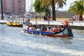 Aveiro, Portugal - July 17, 2019: A group of tourist in Moliceiro, Traditional boat in Aveiro, sailing on the canal in Aveiro, Royalty Free Stock Photo