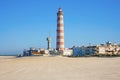 Aveiro, Portugal - March 2019: Lighthouse of Praia da Barra during the day, with a clear blue sky. Deserted beach.