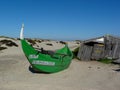 Aveiro, Portugal-DecembBoat stranded on the dune and broken wooden house.