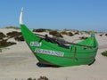 Aveiro, Portugal-DecembBoat stranded on the dune and broken wooden house.