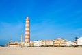 Sunny view on small beach town Praia da Barra, old lighthouse, empty beach, bright small houses Aveiro, Portugal