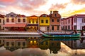 Aveiro, Portugal, Traditional colorful Moliceiro boats docked in the water canal along Cais dos Mercanteis street