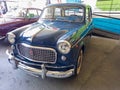 Fiat 1100 103 blue sedan circa 1960. Small classic family car. Front view. Expo Fierros 2021