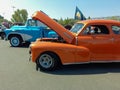 orange Chevrolet Fleetmaster 1947 coupe classic car. Open hood showing engine. Side view. Copyspace Royalty Free Stock Photo