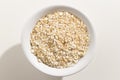 Oat cereal grain. Top view of grains in a bowl. White background Royalty Free Stock Photo