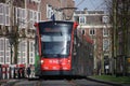 Avenio R-NET red black street car tram on line 15 on the Vijverberg in The Hague in The Netherlands Royalty Free Stock Photo