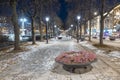 Avenue in Oslo on Karl Johans street during night in winter, with icy ground and light lamps turned on. Beautiful winter night in