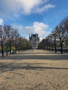 Avenue of trees in autumn leading to the Musee du Louvre in Paris France Royalty Free Stock Photo