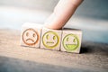 Average Feedback Concept With Red, Yellow And Green Smiling Faces On Wooden Blocks On A Board, The Yellow Face Is