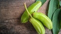 Averrhoa starfruit or Oxalidaceae, Cucumber Fruit with wood texture background