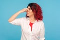 Aversion to fart smell. Portrait of girl with fancy red hair frowning in disgust and pinching nose Royalty Free Stock Photo