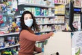 Avetrana, Italy, - Marth, 13, 2020. Beautiful young cashier with medical mask and gloves working at the supermarket. Respecting