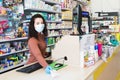 Avetrana, Italy, - Marth, 13, 2020. Beautiful young cashier with medical mask and gloves working at the supermarket. Respecting