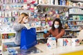 Avetrana, Italy, - Marth, 13, 2020. two young salesewomen with medical mask and gloves working at the supermarket. Respecting