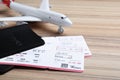 Avia tickets, passports and plane on wooden table, closeup. Travel agency concept
