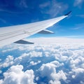 aviation as an airplane\'s wing soars through the vast, clear blue sky.