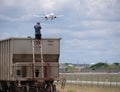 Aviation fan plane spotter risks life to climb on train to take airplane photos at Miami Airport