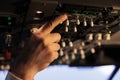 Aviation pilot using control panel in cockpit to fly airborne aircraft Royalty Free Stock Photo