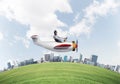 Aviator driving propeller plane above city Royalty Free Stock Photo