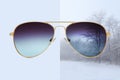 Aviator sunglasses isolated on blue and winter background with snow covered trees, concept of polarized protective lenses Royalty Free Stock Photo