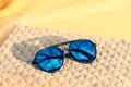 Aviator Sunglasses special model with big blue lenses reflecting the sun in a summer day shoot outdoors closeup