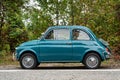 Avigliana, Italy. October 10th, 2020. Side view of classic old FIAT 500L in blue marine color parked along the road leading to the