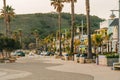 Avila Beach city promenade filled with restaurants, shops, patios, benches, and art. Sunset in the city, dinner time