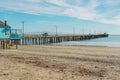 Wide sandy beach, and a long wooden pier, Avila beach pier, California Central Coast