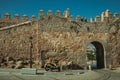 Street with open gateway in the city wall of Avila