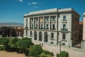 Sumptuous building with flags in front of square at Avila