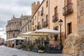 Avila, Spain, medieval narrow cobbled street with restaurants and cafes, Wall of Avila (Muralla de Avila).