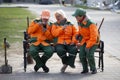 Avitut village. A group of janitors are sitting on a bench. City cleaners