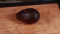 avocado artistry: woman hands cutting avocado on wooden board