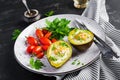 Avocado baked with egg and fresh salad. Vegetarian dish.